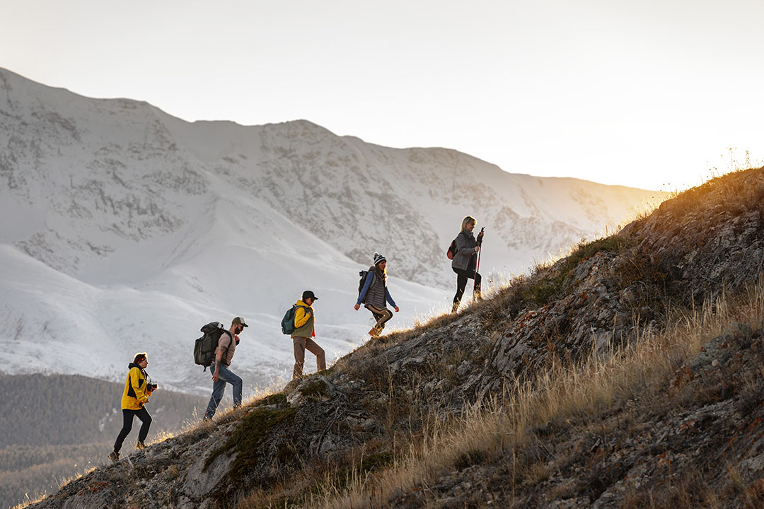 Backpackers hiking up a hill